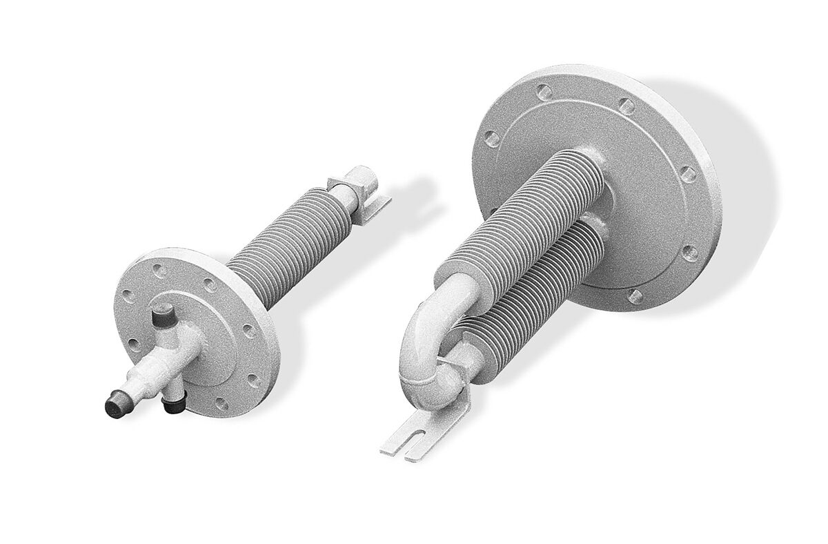 Two Armstrong International heavy-duty tank heaters with finned pipe construction for industrial heat transfer applications.